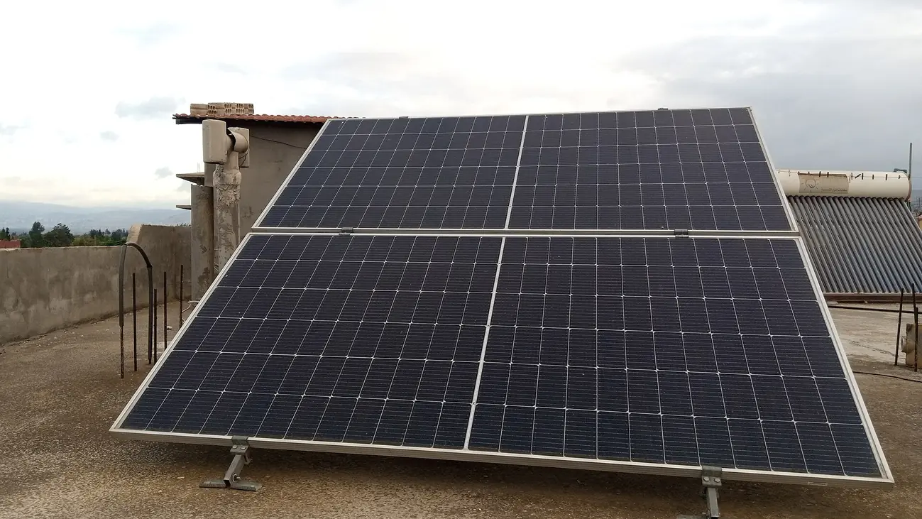 Residential rooftop photovoltaic array of four panels in Syria.jpg